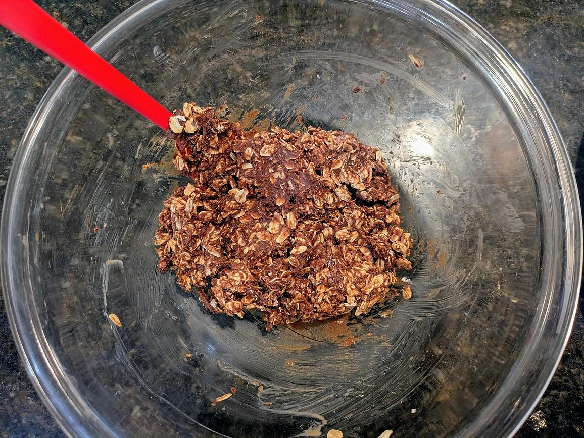 Thin out with water as needed to get everything just fully combined together. You should have to fold with the spatula to mix. It should look slightly too dry to be able to stick to all the oats, but should feel slightly sticky to the touch