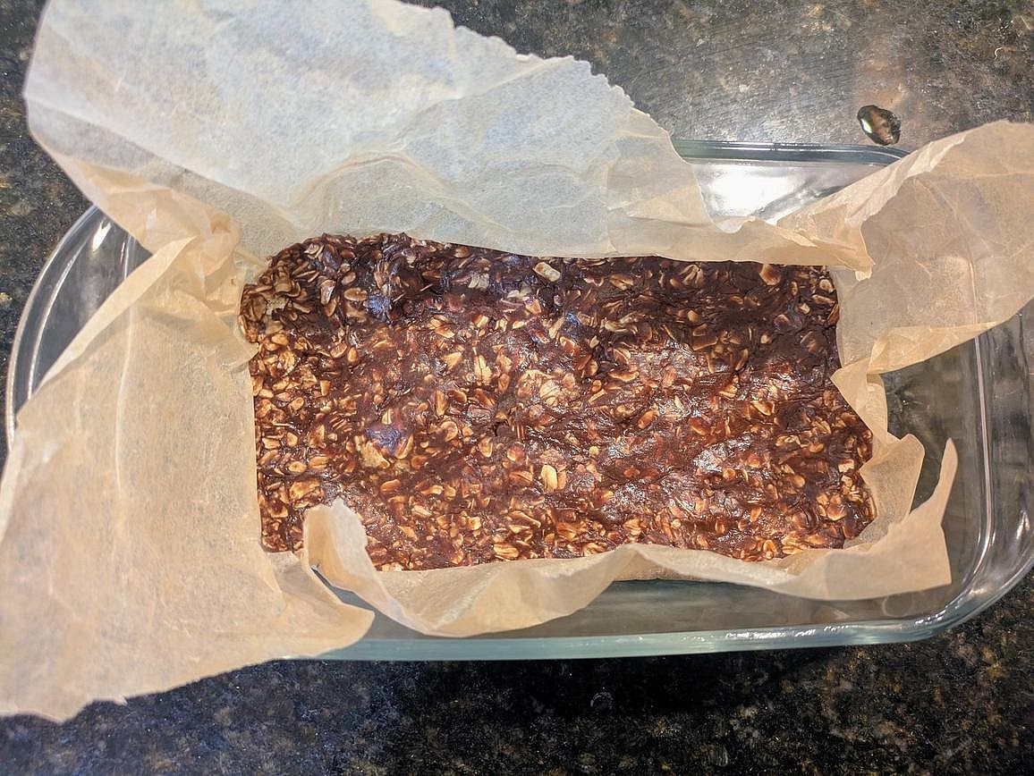 Lightly wet your hands (or use kitchen gloves) and press the dough into all edges of the pan, making sure to pack it down to even thickness