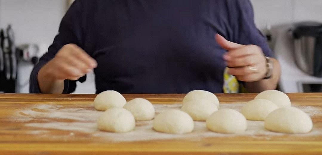 Divide dough into small balls (the size of a plum or larger, depending on your preference). Let them rest for 10 minutes.