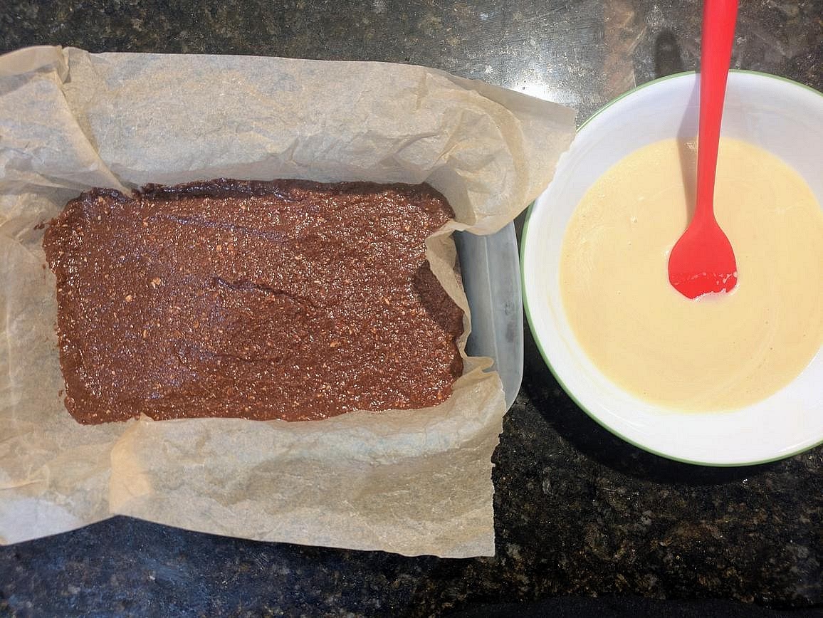 Roughly chop your chocolate, and add to a medium microwave safe bowl with water. Microwave in 15 second intervals, stirring in between with a silicone spatula, until you have a smooth ganache