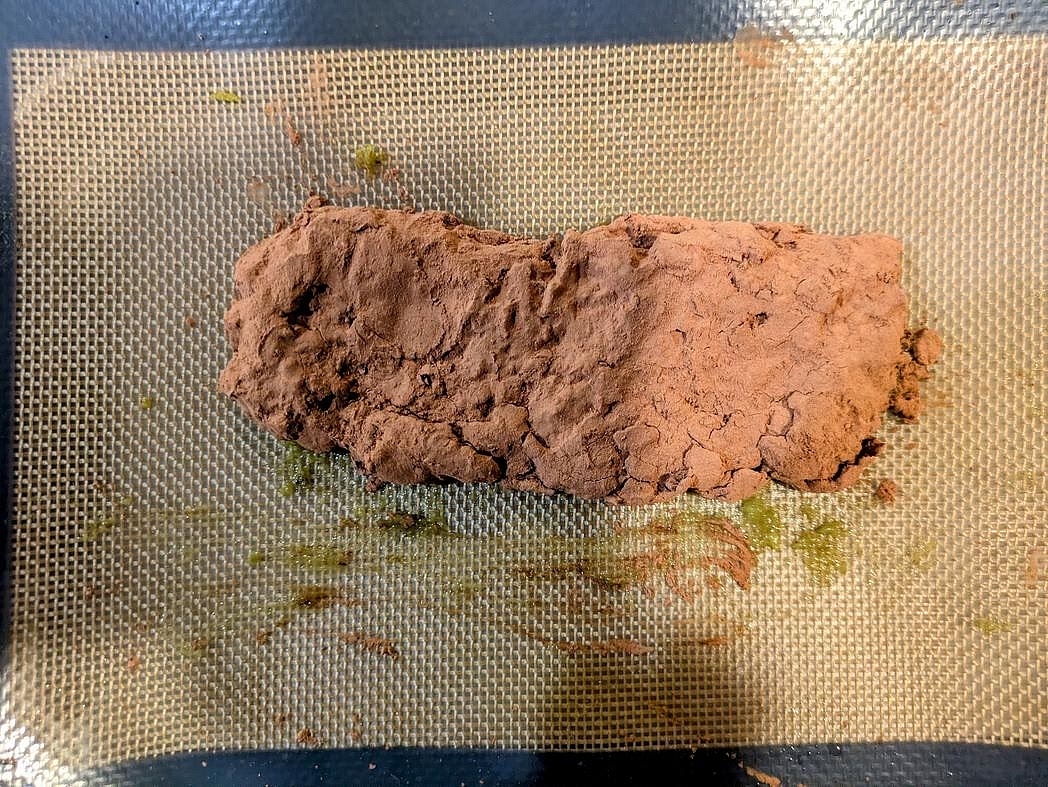 Add carob (or cocoa) to a plate. Coat the protein bar in the powder. Store in the freezer