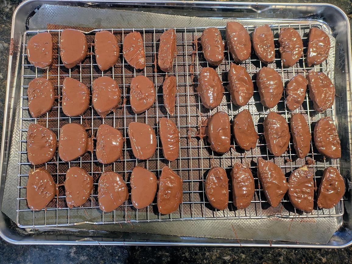 Using 2 forks, dip the marzipan in the chocolate. Transfer to the wire rack so the excess chocolate drips off