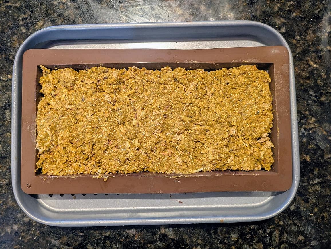 Combine the cereal/coconut mixture with the pistachio butter mixture. Add your pistachio/crunchy mixture on top of the base of chocolate, packing it down to all sides