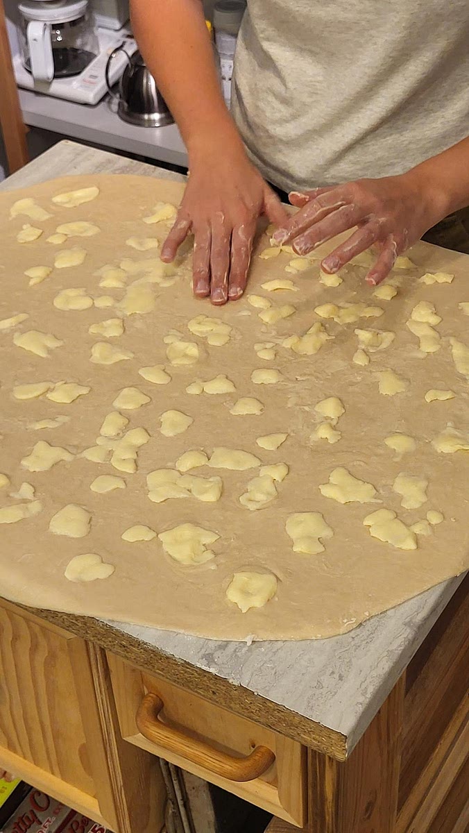 Roll dough with a rolling pin, on a well floured surface, into ≈ 13" x 9" rectangle.
Spread the warm butter on top with a stiff spatula, or fingers. Sprinkle cinnamon and brown sugar generously. Roll up tightly from the long side, then cut into 12 even pieces. *“Try folding the end of a roll under itself, and cutting thicker/taller.” Place in a 13" x 9" x 2" metal baking dish (no parchment needed). Let rise covered, until doubled, either :
In a warm oven (OFF) (≈ 1hr) or. At room-temp (≈ 2hrs) or. In the fridge (≈ 8hrs)