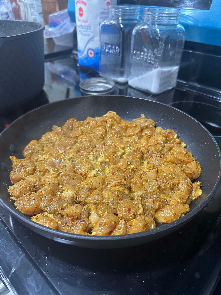 Add spices to your cut up chicken. Let sit for 10 mins. Lightly fry the chicken.