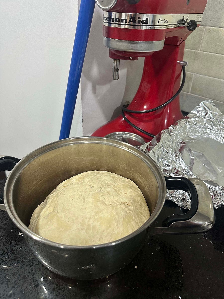 Cut the dough into equal parts, roll out dough into little circles. Use water on eyes to close off bun. Add in chicken filling with some cheese and shape into ball.