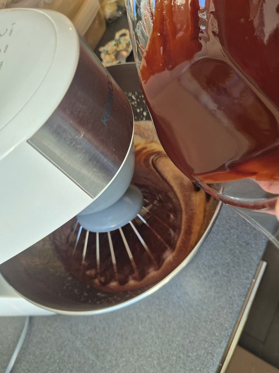 Pour the melted chocolate mixture into the egg mixture. Add the vanilla extract and rum or liqueur, if using. Mix gently to combine.