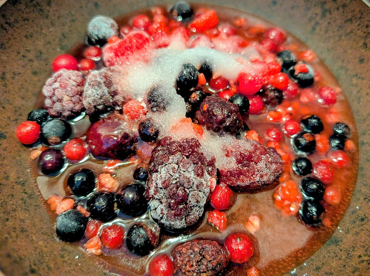 In a saucepan, combine berries, sugar, honey, lemon juice, and water.