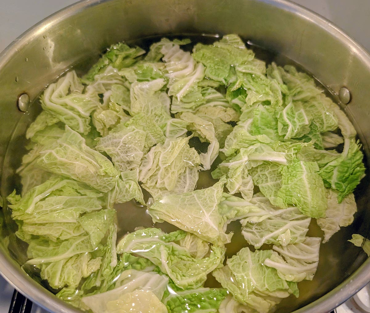 In a large pot of salted boiling water, add the potatoes and savoy cabbage, then cover it with a lid and bring it back up to a boil.