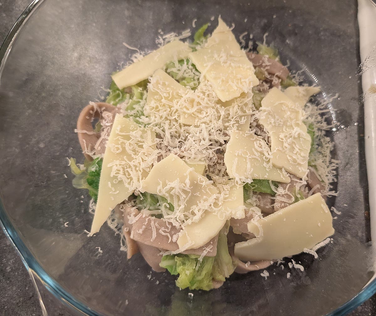 Once the pasta is cooked , add a layer of pasta and veg mix in the serving tray then a layer of the melting cheese shavings (about half the cheese) and a sprinkle of Parmesan. Repeat with another layer of pasta and veg, the rest of the Fontina, a sprinkle of parmesan, and a final of pasta and veg.