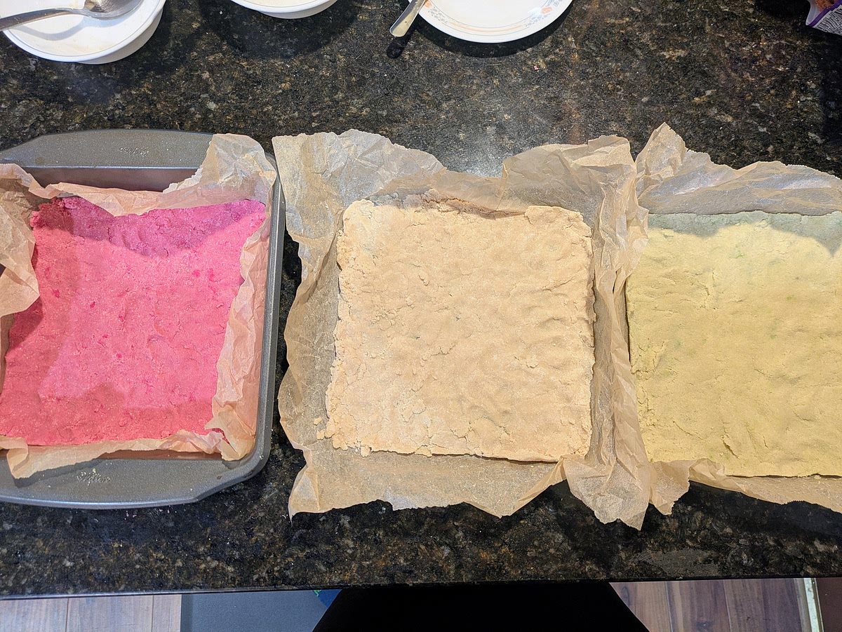 Line a 9" square pan with parchment paper. Evenly press the red layer into the pan
