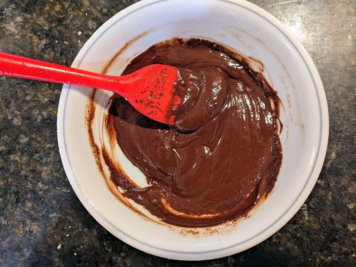 Add chocolate chips, coconut oil, and almond milk to a small bowl. Microwave for 30 seconds, and stir with a silicone spatula to make your ganache