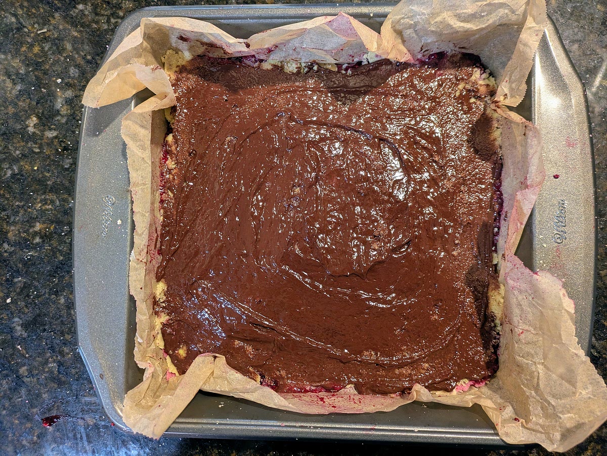 Pour the melted chocolate on top of the green layer, carefully and evenly spreading it to all sides