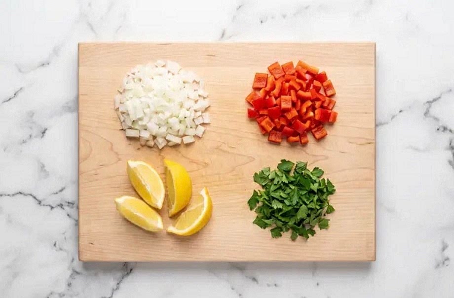 Bring 5 cups water(8 cups for 4 servings) to a boil in a medium pot. Once boiling, reduce heat to low to keep warm. (TIP: Start with hot water to speed things up!) Wash and dry produce. Using your hands, roughly break spaghetti in its bag into 1- to 2-inch pieces. Core, deseed, and dice bell pepper into ¼-inch pieces. Halve, peel, and finely dice onion. Quarter lemon. Roughly chop parsley.