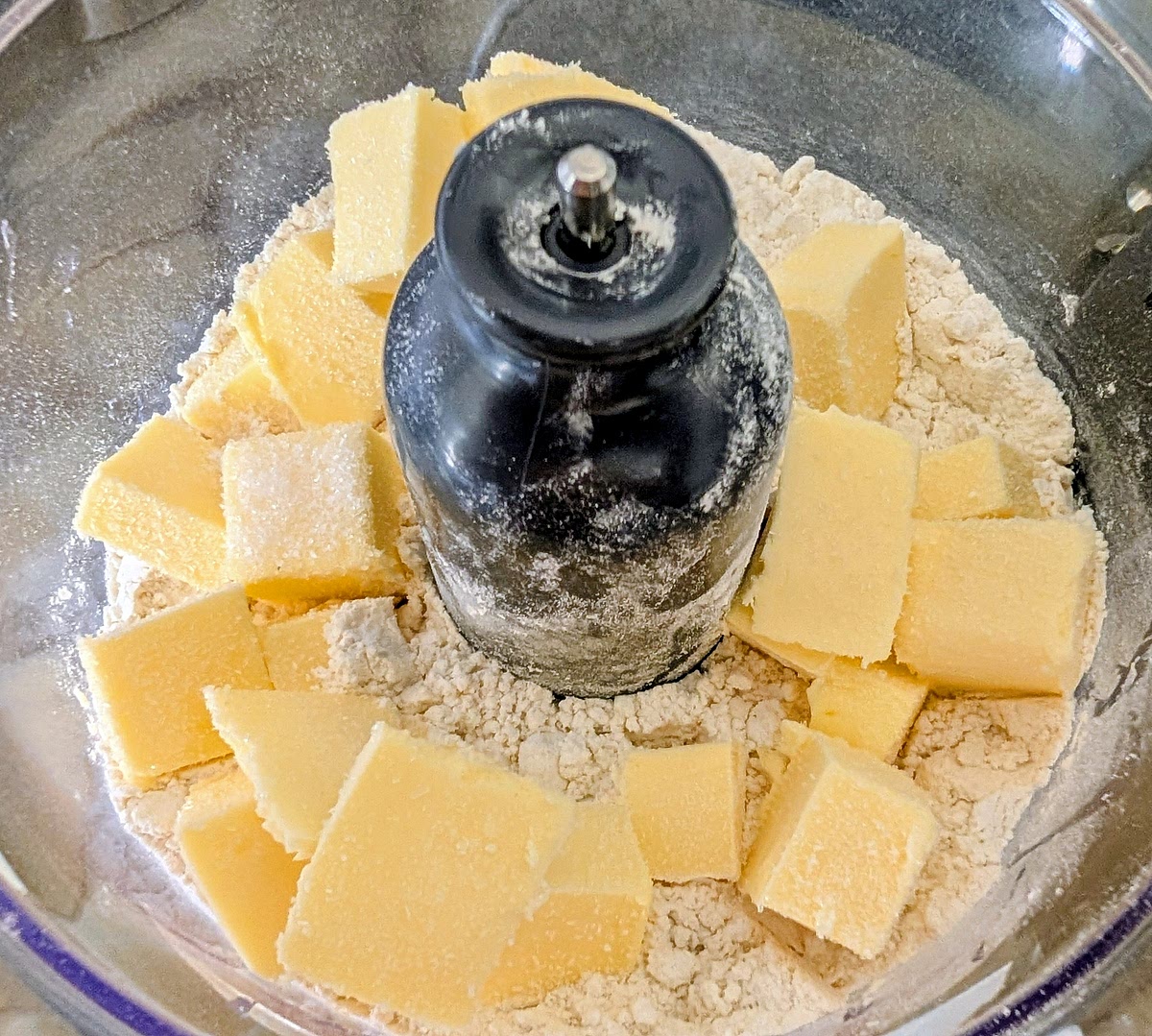 Add the flours, cubed salted butter, a pinch of MSG and a pinch of salt to the bowl in a food processor.