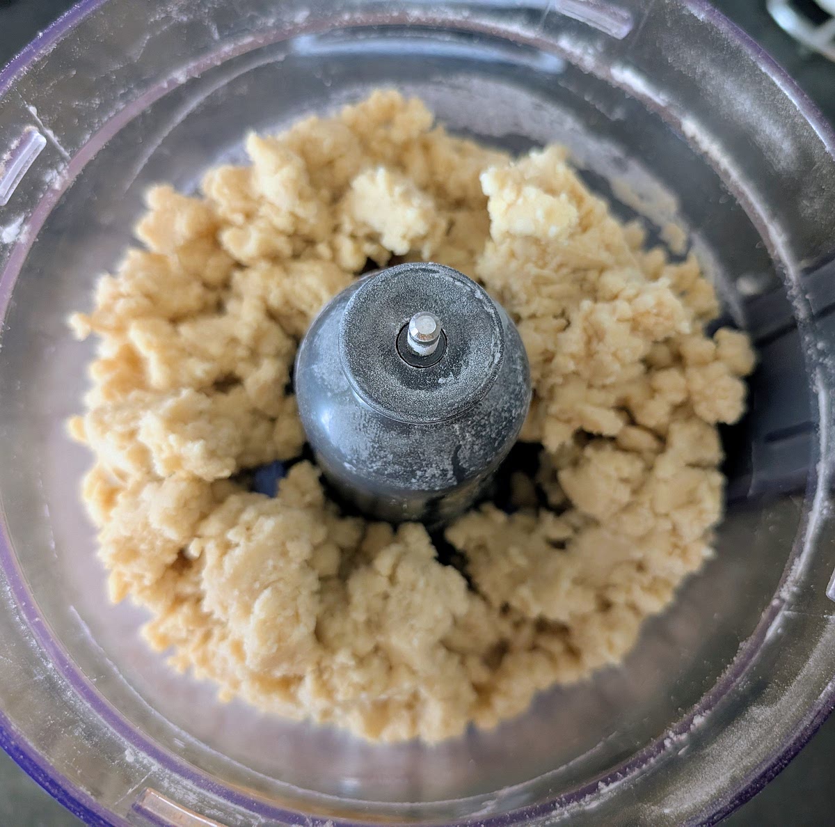 Pulse in the processor until the mix looks like fine breadcrumbs, then add the large egg and pulse until it comes together as a dough. If it seems to be struggling or looks too dry, add a dash of cold water.