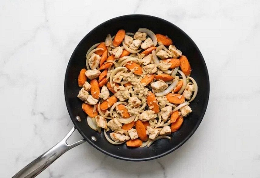 Open package of chicken* and drain off any excess liquid. Season all over with salt and pepper. Heat a large drizzle of oil in a large pan over medium-high heat. Add carrots and onion; cook, stirring occasionally, until veggies are beginning to brown and soften, 4-6 minutes. Season with salt and pepper. Add another drizzle of oil, chicken, and garlic-ginger scallion paste. Cook, stirring occasionally, until chicken is lightly browned, 3-4 minutes (it'll finish cooking in the next step).