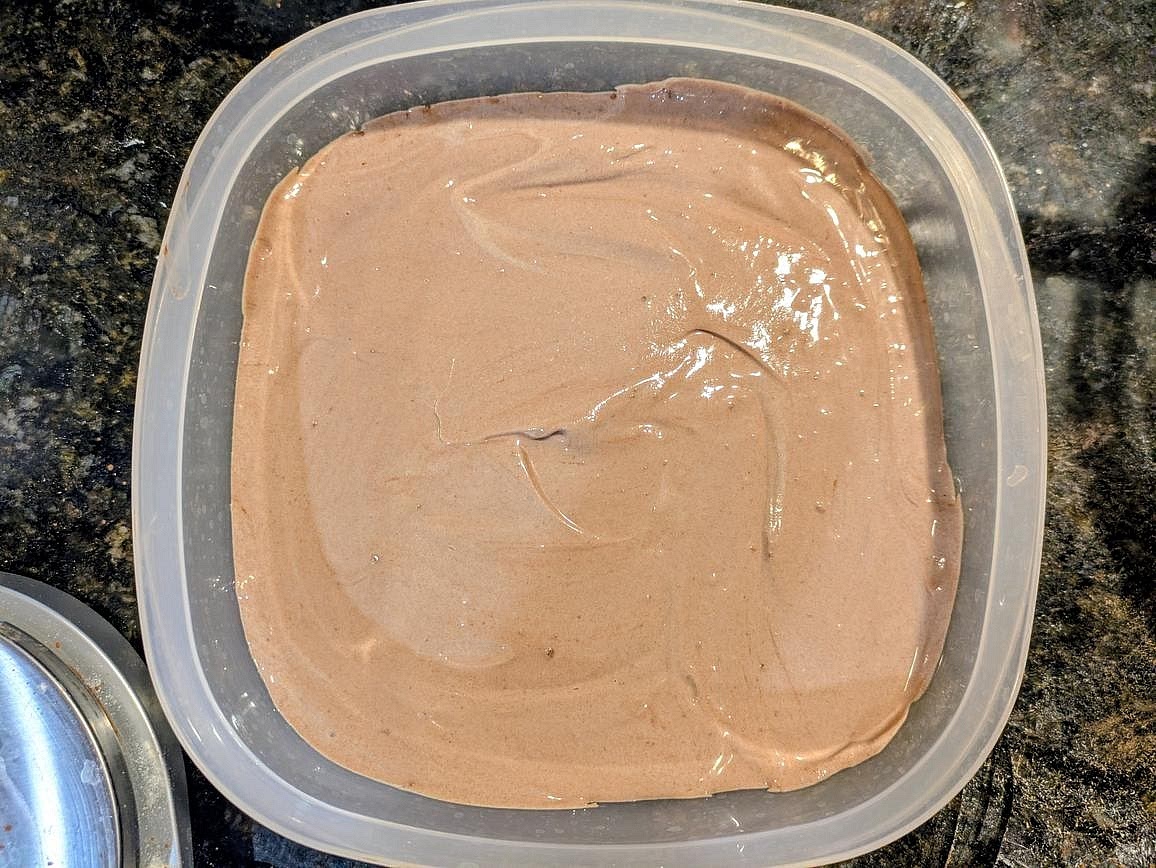 Transfer the frozen yogurt to a wide and flat airtight container, and freeze