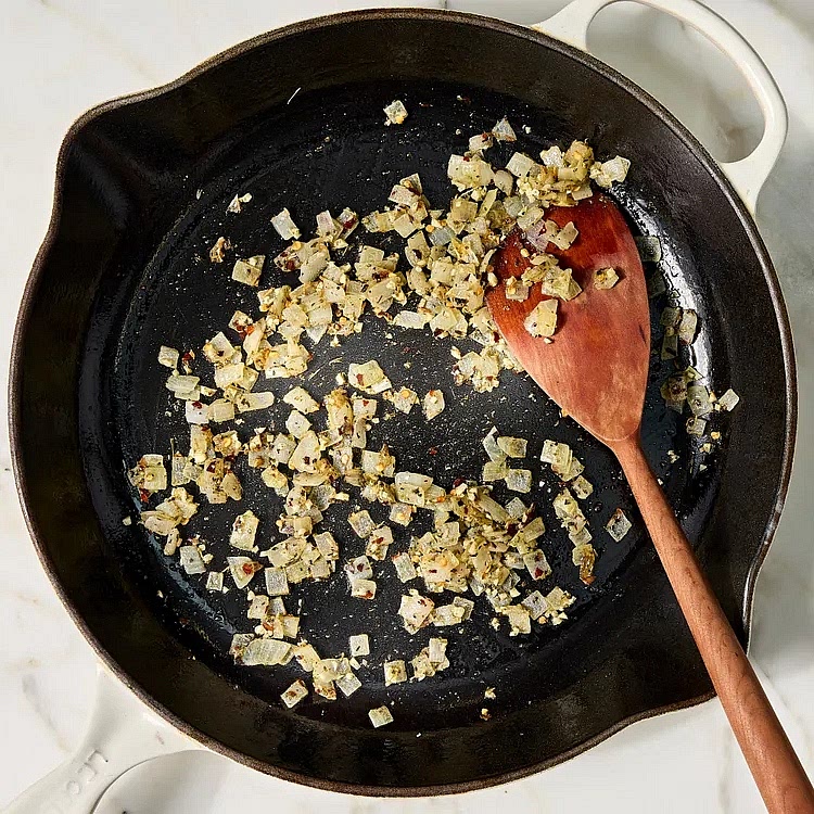 Meanwhile, heat 2 tablespoons oil in a large ovenproof skillet over medium heat. Add ½ cup onion; cook, stirring occasionally, until softened, about 5 minutes. Add 1 tablespoon garlic, 1 teaspoon Italian seasoning and ½ teaspoon crushed red pepper; cook, stirring constantly, until fragrant, about 30 seconds.
