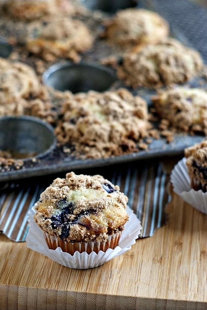 Prep the oven: Preheat your oven to 425°F (220°C) and line a 12-cup muffin tin with paper liners or grease it with nonstick cooking spray.
Mix dry ingredients: In a large bowl, whisk together the whole wheat flour, baking powder, baking soda, and salt.
Mix wet ingredients: In a separate medium bowl, whisk together the Greek yogurt, maple syrup (or honey), oil, eggs, vanilla extract, and lemon zest until smooth.
Combine: Pour the wet ingredients into the dry ingredients. Use a spatula or wooden spoon to gently fold the mixture together until just combined. Do not overmix!
Prep blueberries: Toss the blueberries with 1 tablespoon of flour in a small bowl. This trick prevents the fruit from sinking to the bottom of your muffins while baking. Gently fold them into the batter.
Bake: Divide the batter evenly among your 12 muffin cups. Bake at 425°F for 10 minutes to give them a nice, tall dome, then reduce the heat to 375°F (190°C) and bake for another 10 to 12 minutes.
Check for doneness: Insert a toothpick into the center of a muffin; if it comes out clean or with a few moist crumbs, they are ready. Let them cool in the pan for 10 minutes before transferring to a wire rack.