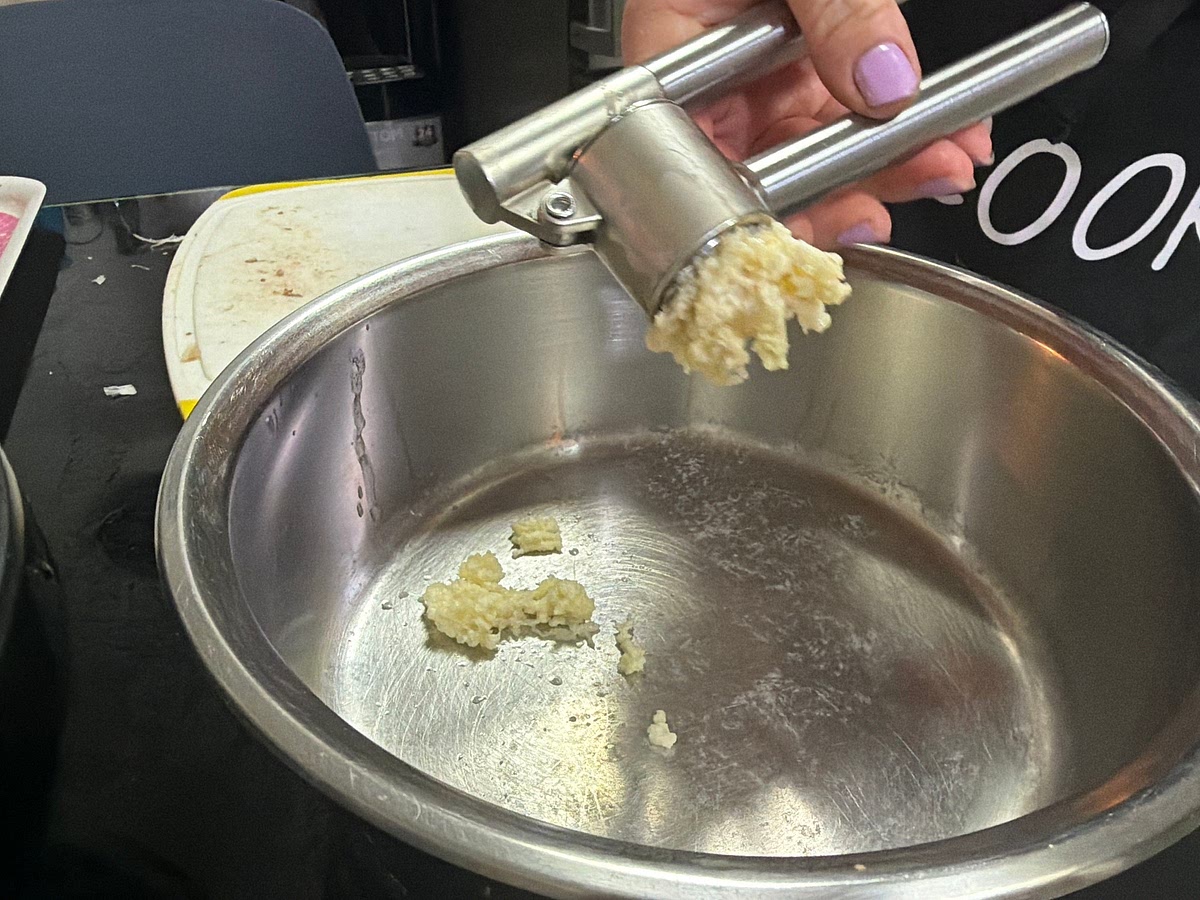 Peel and mash 2 big cloves of garlic into pan