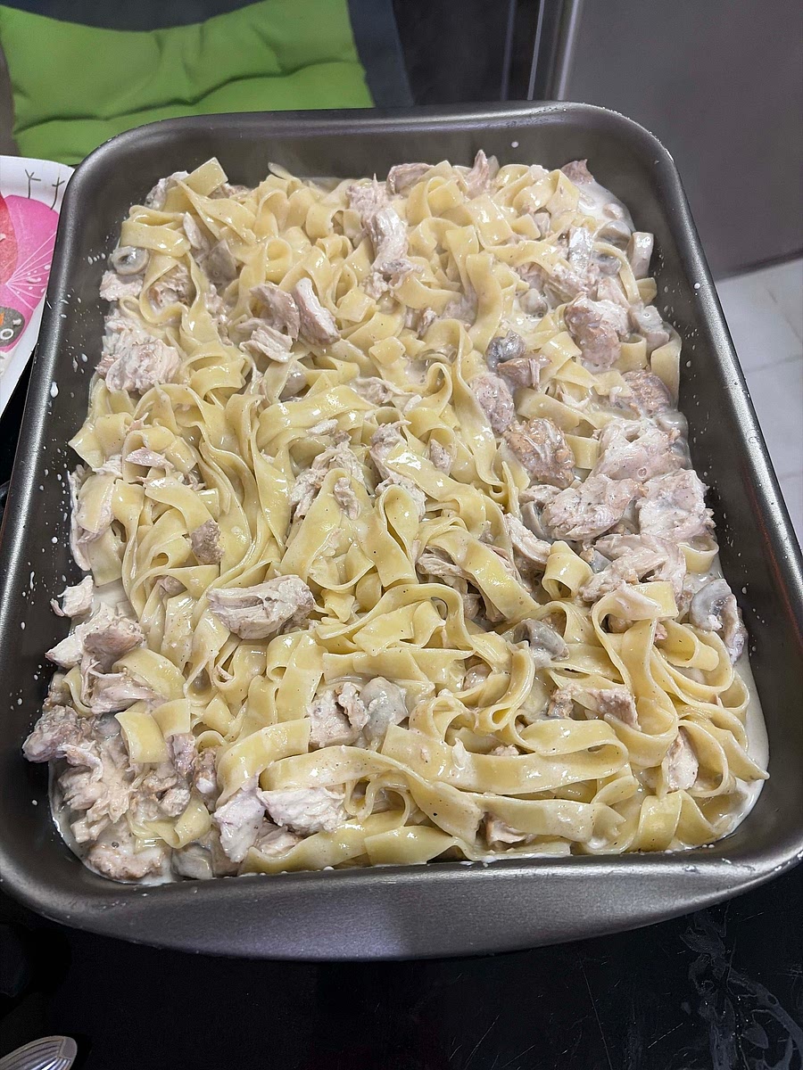 Strain pasta then put into oven tray then mix