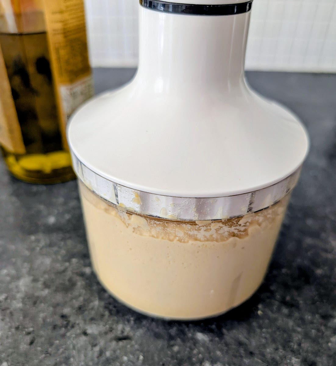 Add the cooked drained chickpeas into a food processor, add the olive oil, water, salt, pepper and MSG, and blitz them untill you have a smooth (hummus like, but drier) paste.