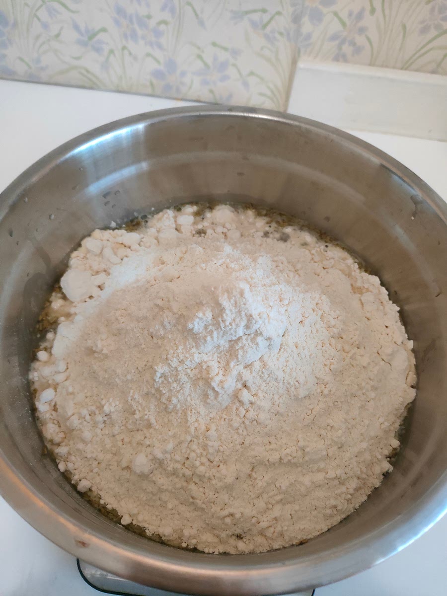 Add wheat. If you don't have a big bowl or a good mixer, it's easier to add it in parts and always mix before adding more.