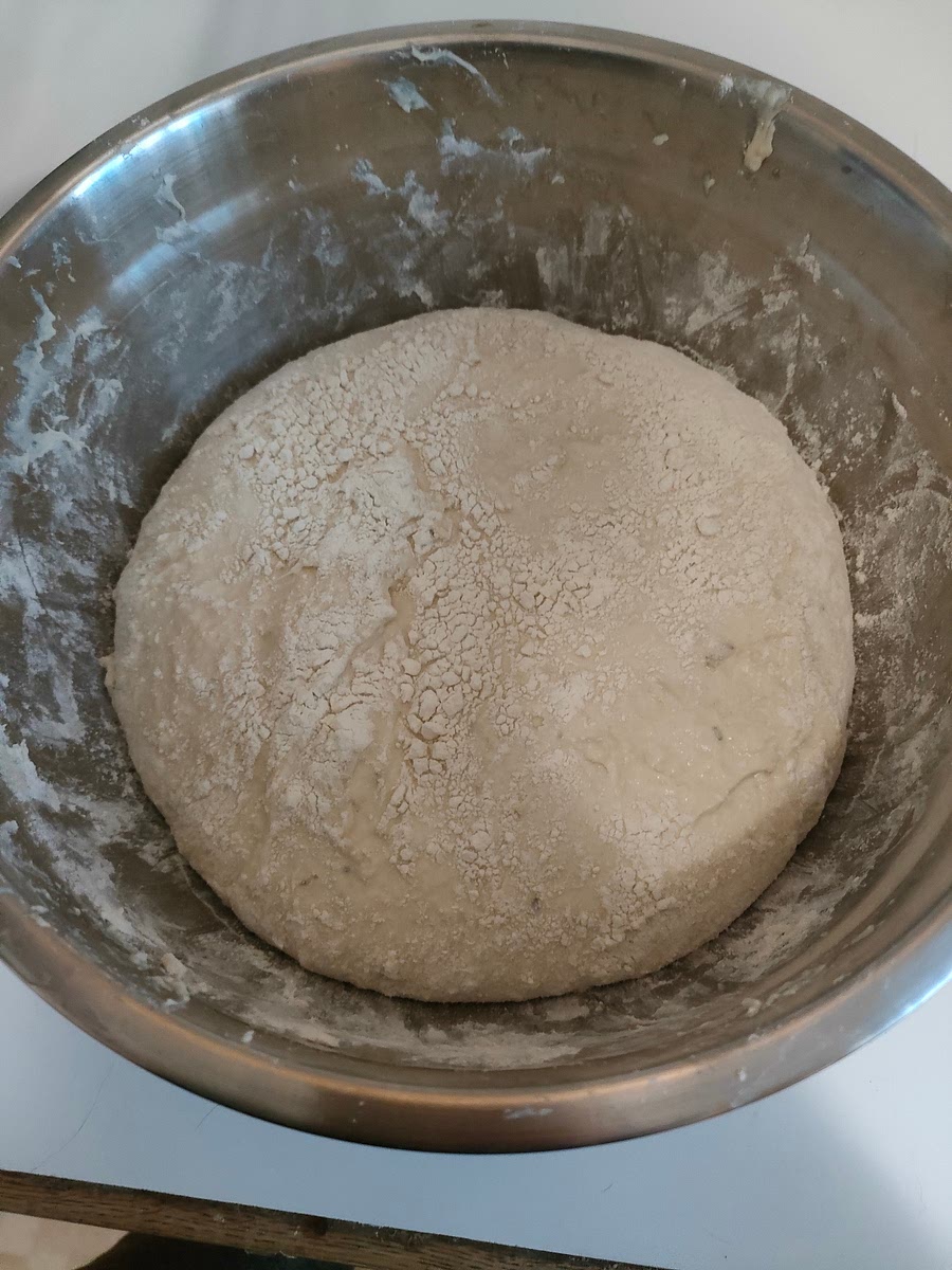 I like to cover the dough with more wheat on top and sides. It helps preventing it from sticking to sides.