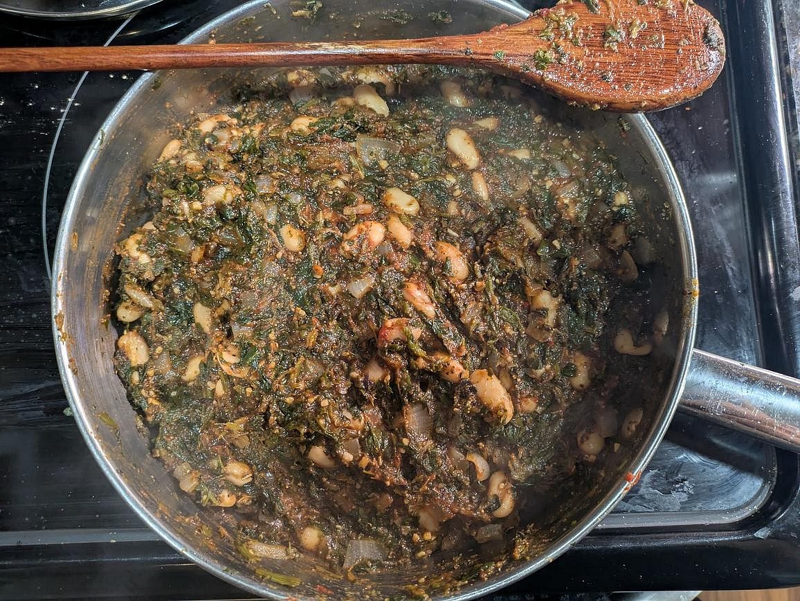 To the pan, add your beans, tomato paste, minced garlic, and spices (basil, oregano, garlic powder, onion powder, black pepper, and red pepper flakes). Mix with a wooden spoon, cover with a lid, and simmer for 5 minutes to warm the beans and thicken the sauce. Meanwhile, heat up your broiler