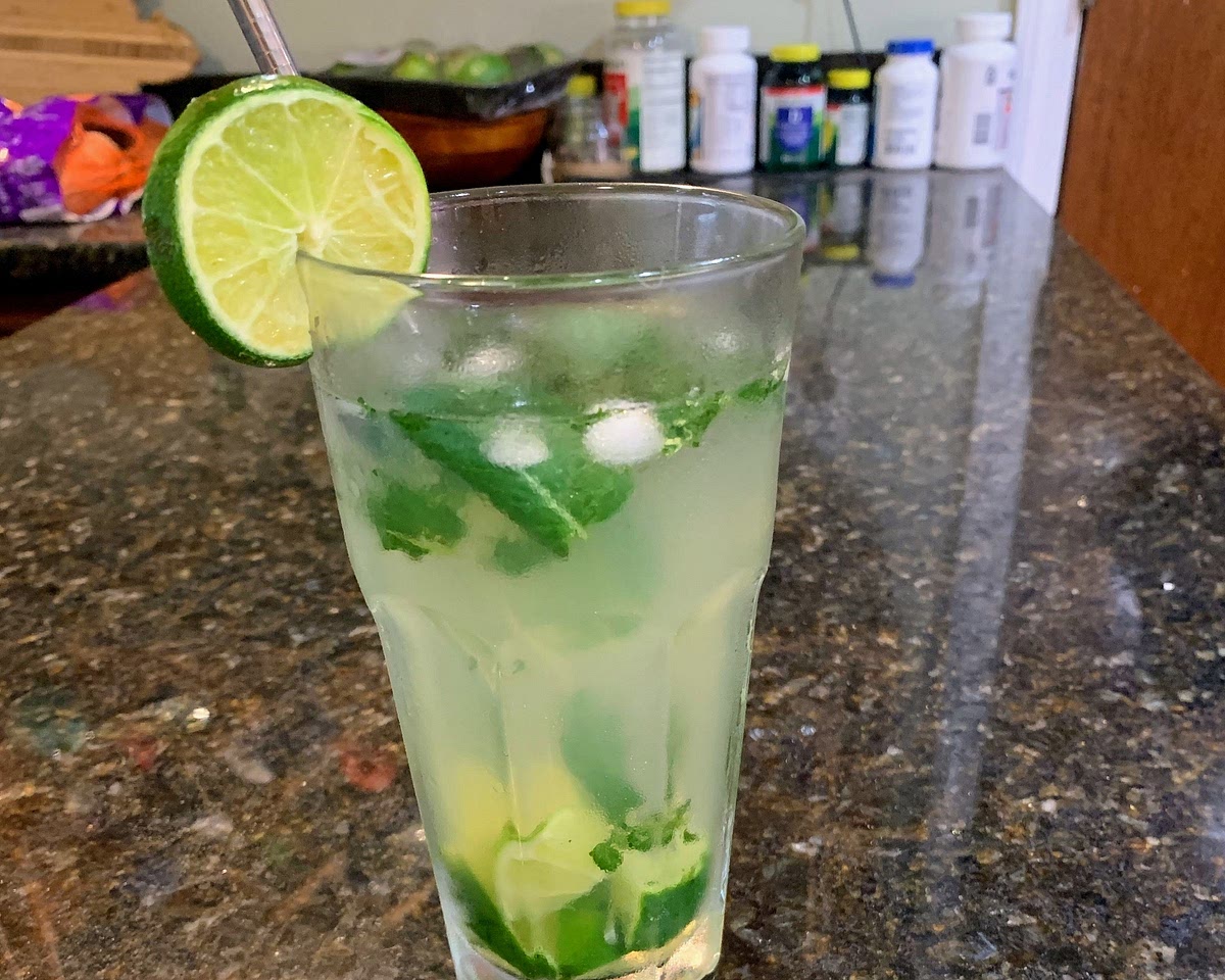 Add liquid monk fruit, ice, and water to the glass. Stir together, and garnish with a like wedge