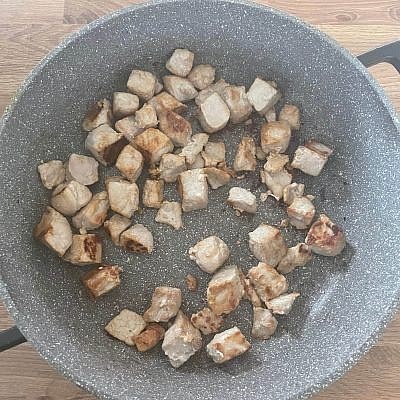 Add 1 tbsp sunflower oil to a large pan over a high heat. Add 500g pork leg to the pan and brown for 3-4 minutes