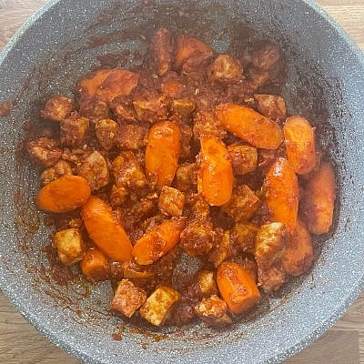 Cut 3 carrots into thick chunks and add them to the pan along with 2 tbsp gochujang, 1 tbsp doenjang, 1 tbsp gochugaru, 2 tbsp honey, 3 cloves minced garlic, ¼ tsp pepper and stir through
