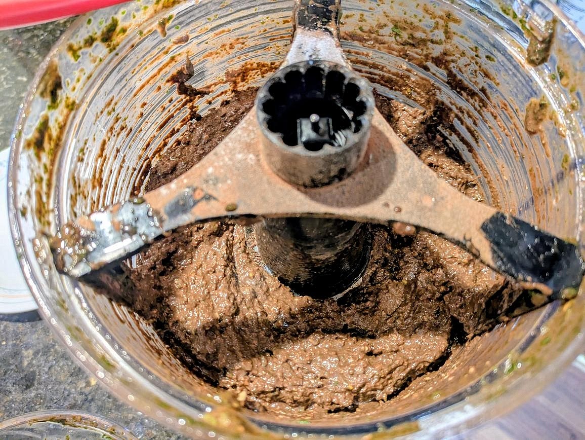 Add all ingredients to a food processor. Blend until fully combined and all the mint is thoroughly chopped into the batter. You should have little to no little green bits of leaves, but still some texture to the nuts