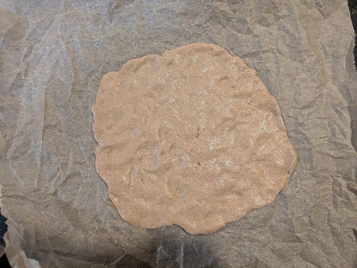 When it's time to make pizza, preheat your oven on its hottest temperature (500F or 550F) for at least 1 hour with a baking stone in the oven. Evenly spread your dough into a round and thin circle on top of a piece of parchment paper. Top with sauce, cheese, and any other desired toppings.
