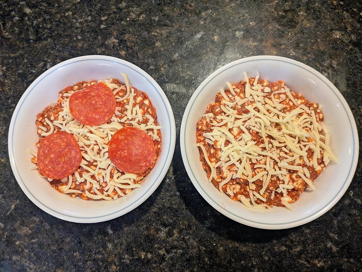 Divide across 2 small microwave safe bowls, about 340 g each. Top each bowl with 1/4 cup (28 g) shredded mozzarella. Add on any other desired toppings.