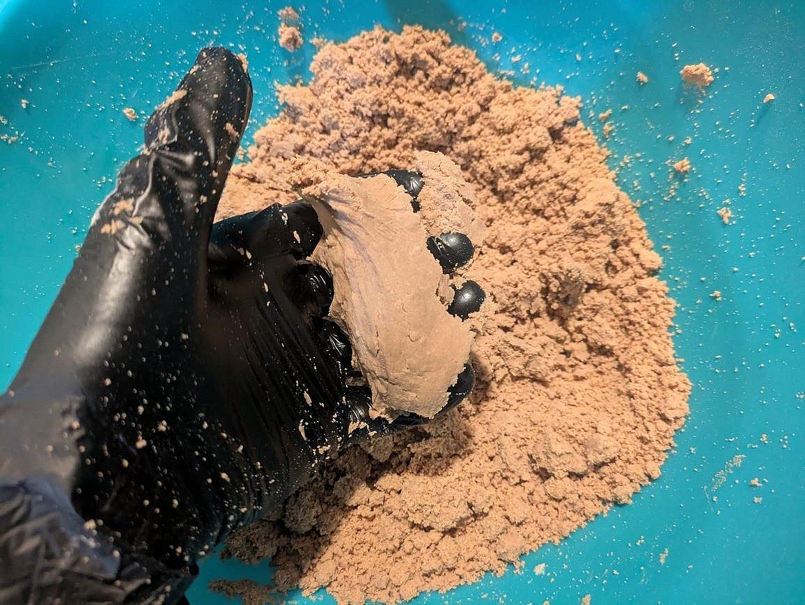 Add in the the water, liquid sweetener, melted coconut oil, and vanilla, and mix with your hand wearing a kitchen glove. The dough should look a little too dry, but hold together easily when pressed.