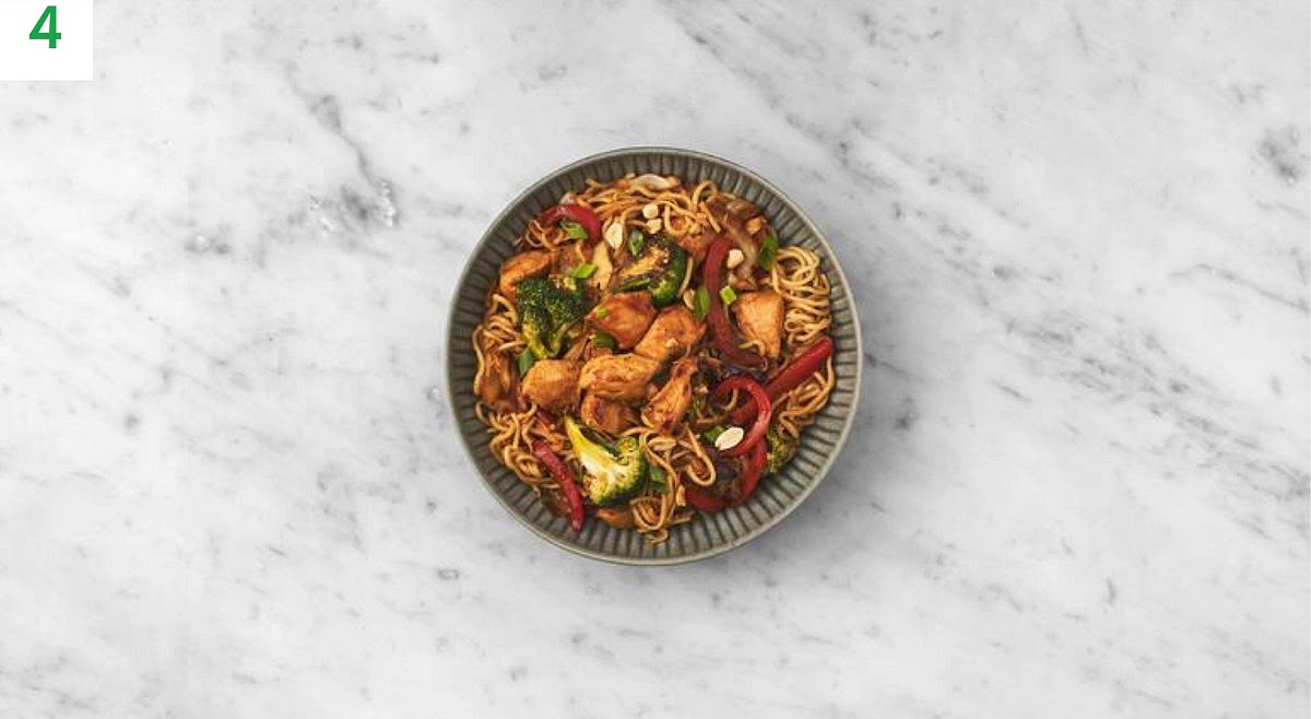 Share the chicken stir-fry between bowls.
Top with the peanuts and spring onion.