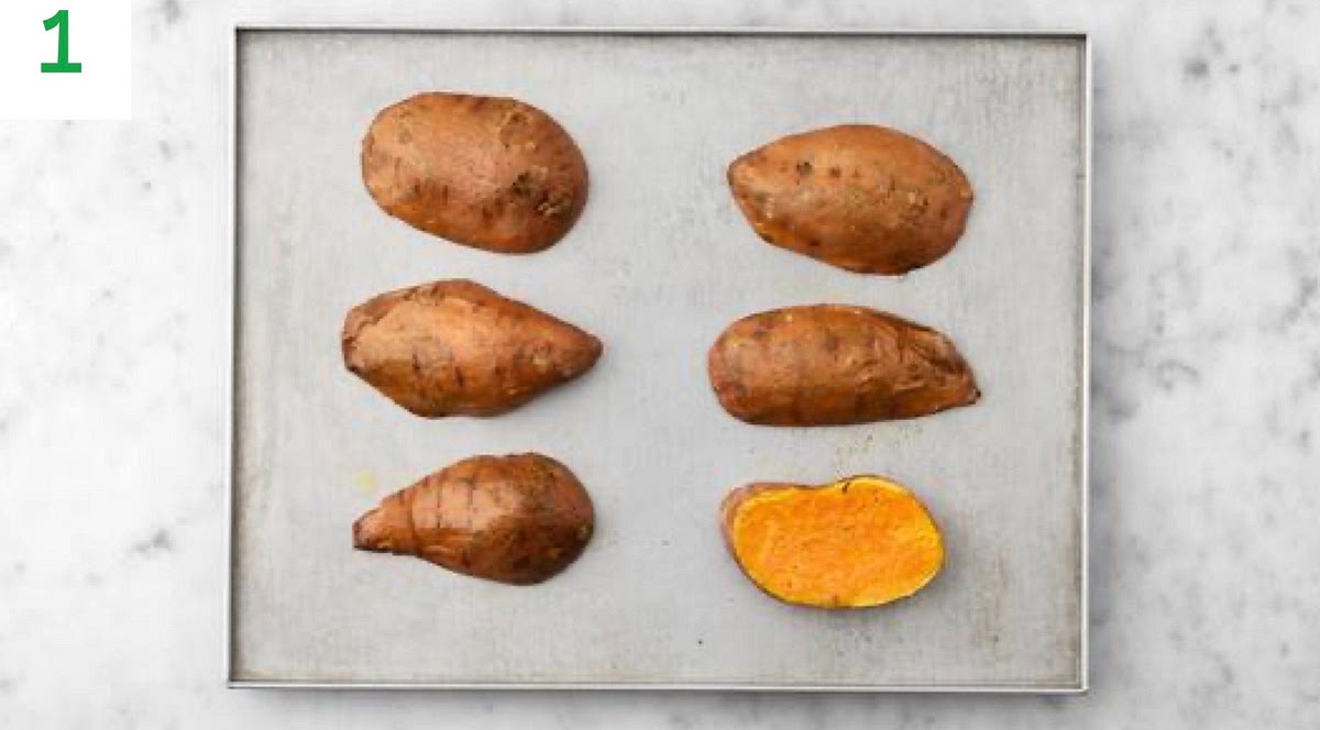 Preheat your oven to 240°C/220°C fan/gas mark 9.
Halve the sweet potatoes lengthways and pop them onto a baking tray. Drizzle with oil and season with salt and pepper. Rub the oil over the potatoes, then lay them, cut-side down onto the tray.
When the oven is hot, roast on the top shelf until tender and a knife slips in easily, 30-40 mins. TIP: Alternatively, if you have a microwave, you can speed things up. Halve the potatoes lengthways, then prick all over with a knife. Rub with a little oil and season with salt. Place cut-side down onto a plate, then microwave on high until tender , 15-18 mins.
