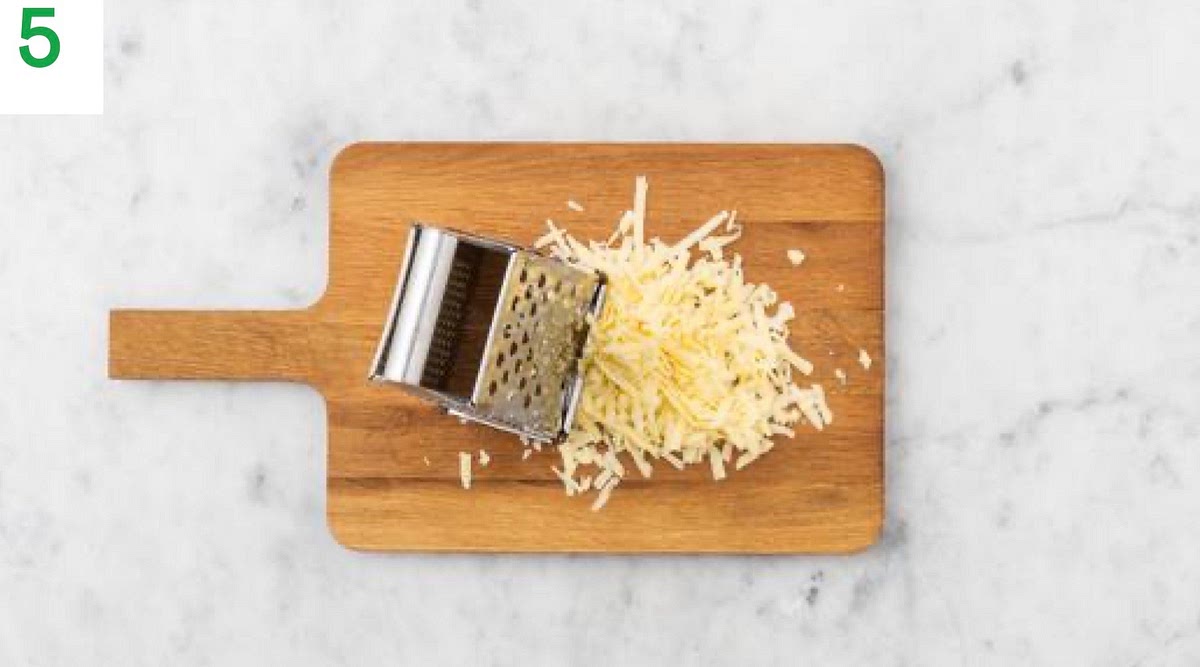 Meanwhile, grate the cheese.
When everything's ready, taste the chilli and season with salt and pepper if needed. Remove from the heat, adding a splash of water if it's a little too thick.