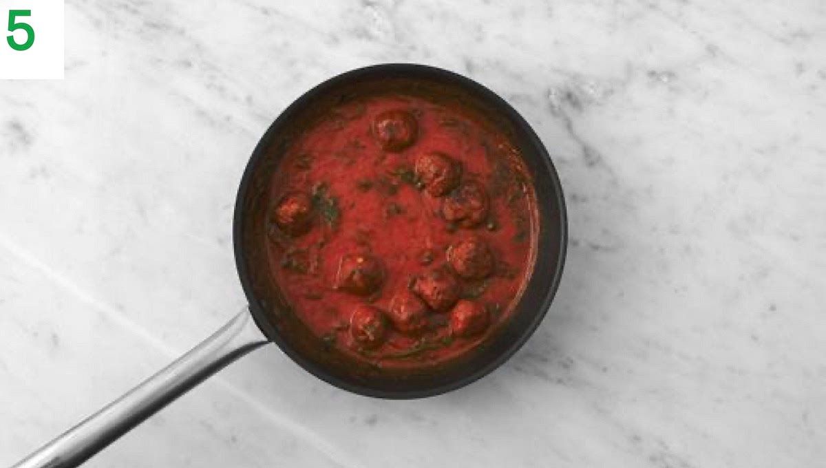 Once the sauce has thickened, stir the cooked meatballs, pasta and cheese through the tomato sauce. Toss to coat.
Taste and season with salt and pepper if needed. Add a splash of water if the sauce is a little too thick.