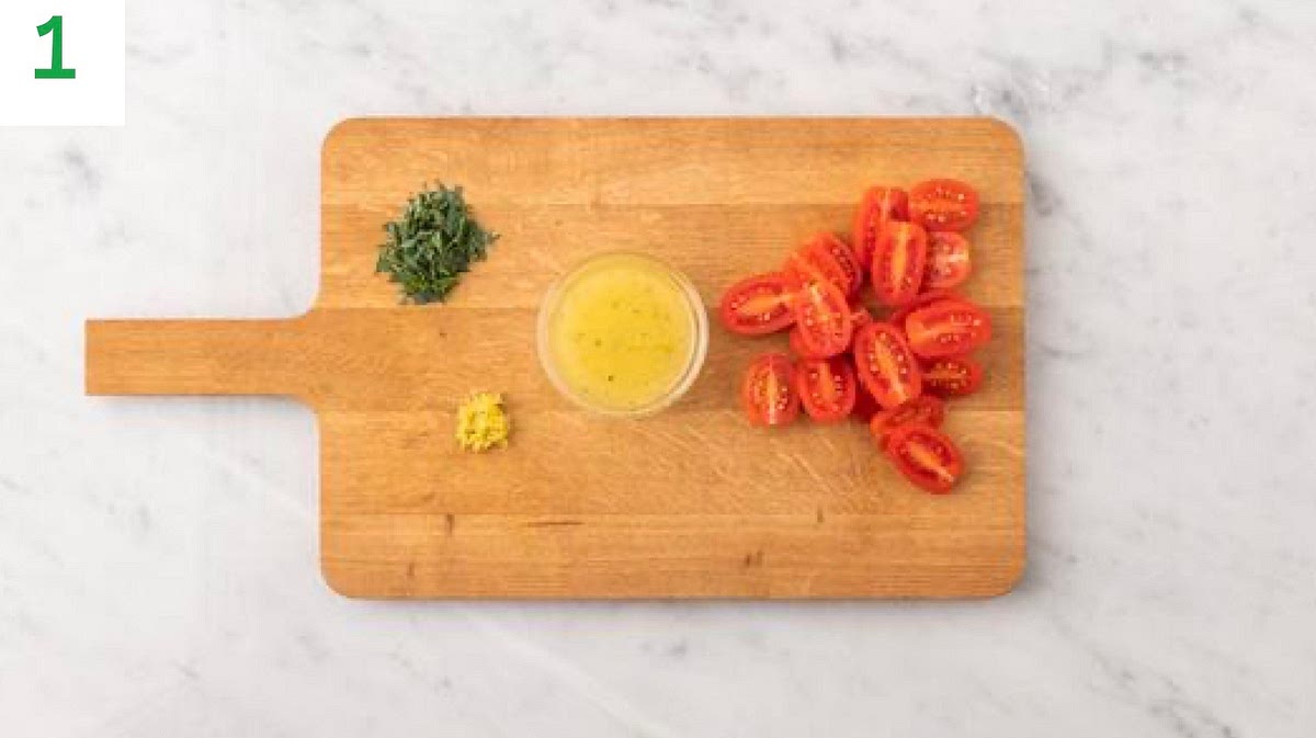 Preheat your oven to 220°C/200°C fan/gas mark 7.
Boil a full kettle.
Halve the baby plum tomatoes.
Zest and halve the lemon. Squeeze the lemon juice into a medium bowl and add the olive oil for the dressing.
Season with salt and pepper, mix together, then set aside.
Pick the tarragon leaves from their stalks and roughly chop (discard the stalks).