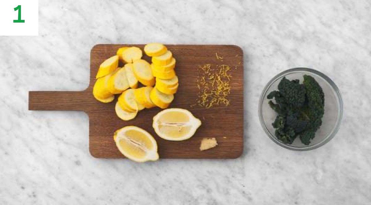 Boil a full kettle.
Peel and grate the garlic (or use a garlic press). heat.
Trim the yellow courgette and slice into 1cm thick rounds. Zest and halve the lemon.
Discard any thick stems from the kale.