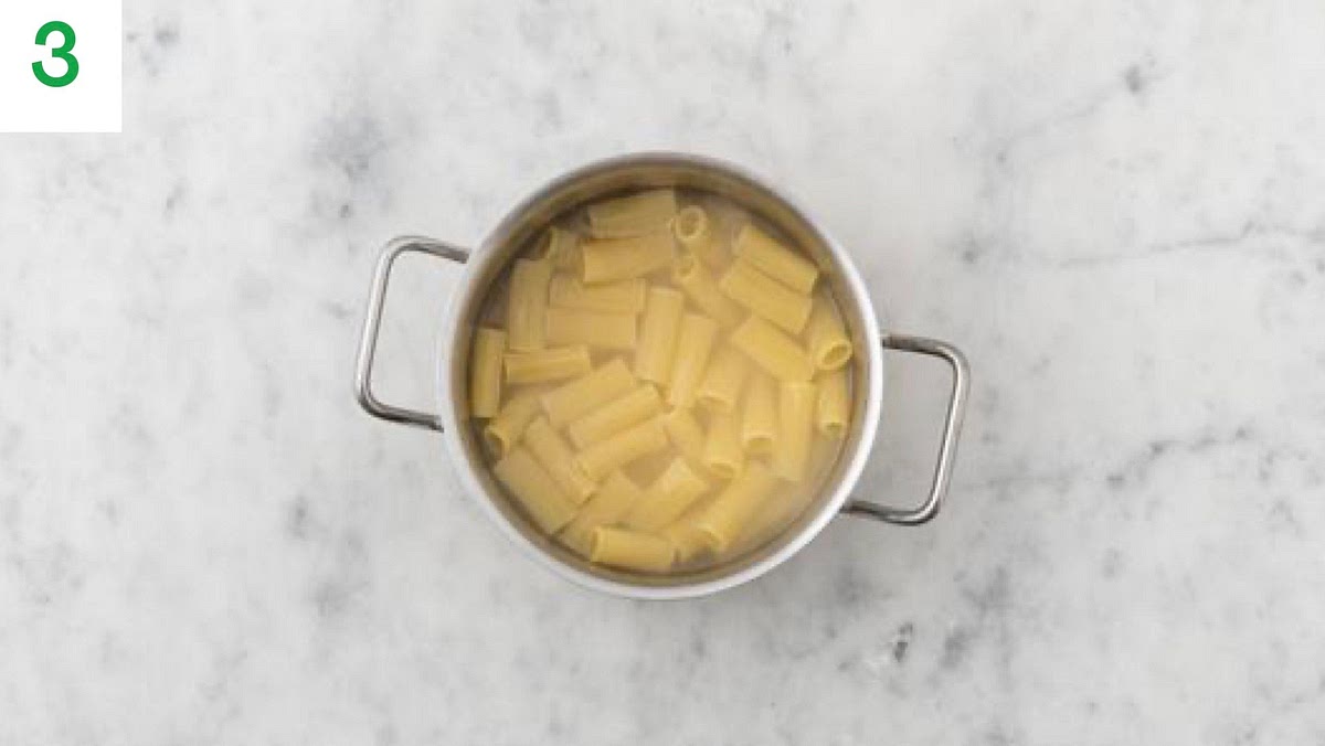 Return the (now empty) saucepan (no need to clean) to the high heat and pour in the boiled water from the kettle. Add 1/2 tsp salt and bring to the boil. When boiling, add the rigatoni to the water and bring back to a boil. Cook until tender, 12 mins.