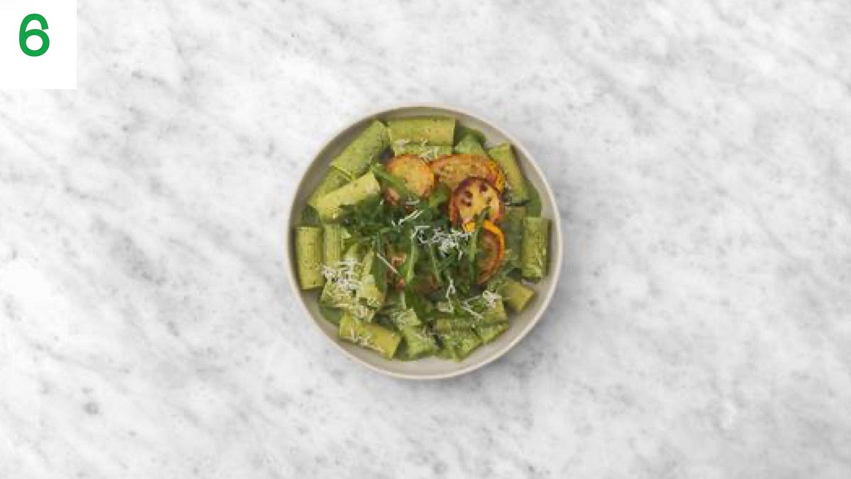 When everything’s ready, share the green chilli rigatoni between your bowls.
Top the paste with the yellow courgette rounds and rocket.
Sprinkle over another pinch of lemon zest and drizzle a little olive oil over the leaves to finish.