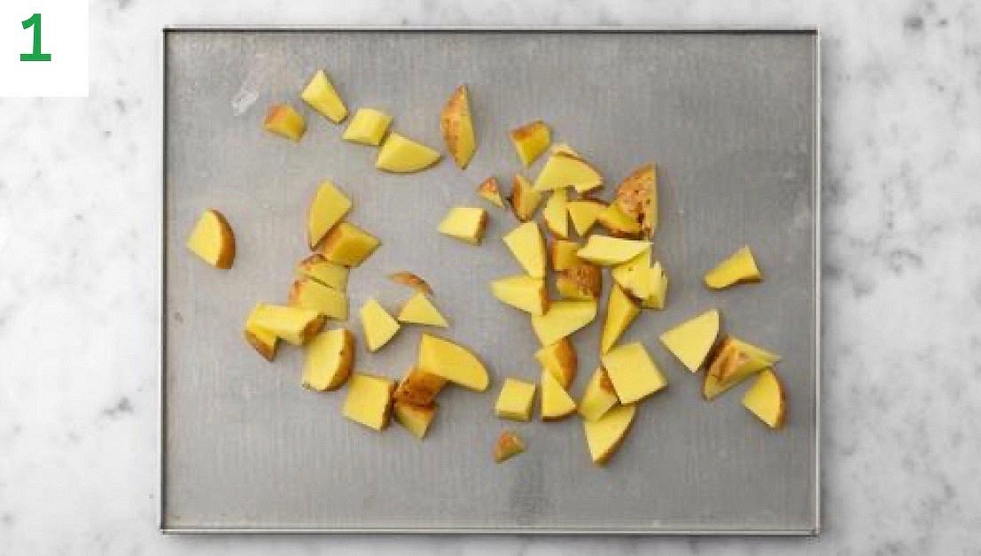 Preheat your oven to 220°C/200°C fan/gas mark 7.
Chop the potato into 2cm chunks (no need to peel).
Pop the chunks onto a large baking tray. Drizzle with oil, season with salt and pepper, then toss to coat.
Spread out in a single layer. TIP: Use two baking trays if necessary.
When the oven is hot, roast on the top shelf until golden, 25-35 mins. Turn halfway through.