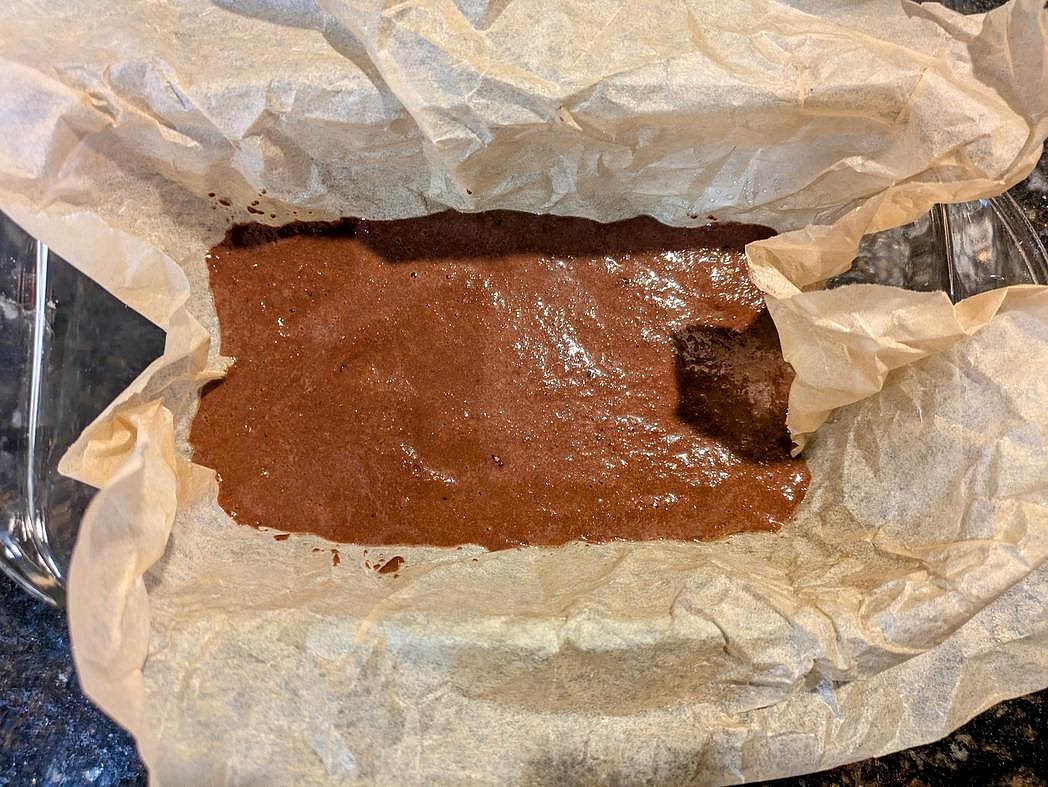 Transfer the batter to the pan. Wipe out the excess brownie batter from the bowl with a paper towel.