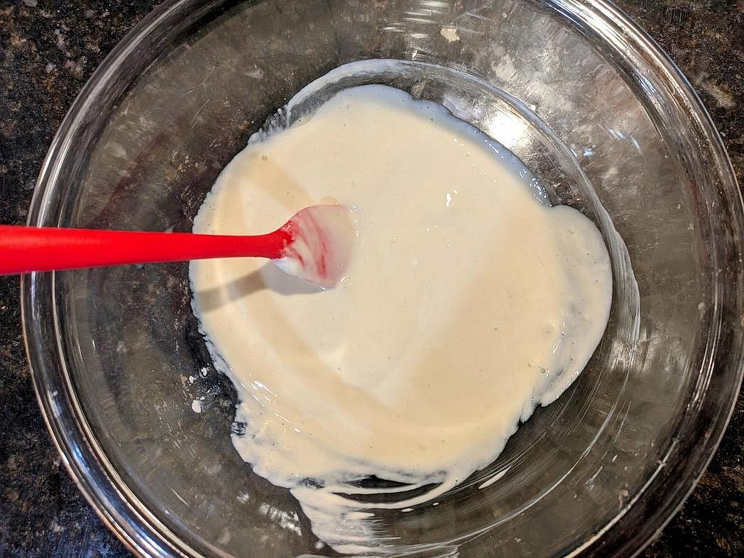 Add your cheesecake ingredients to the bowl, and mix until fully combined with a silicone spatula - yogurt, egg, vanilla, liquid sweetener, and salt.