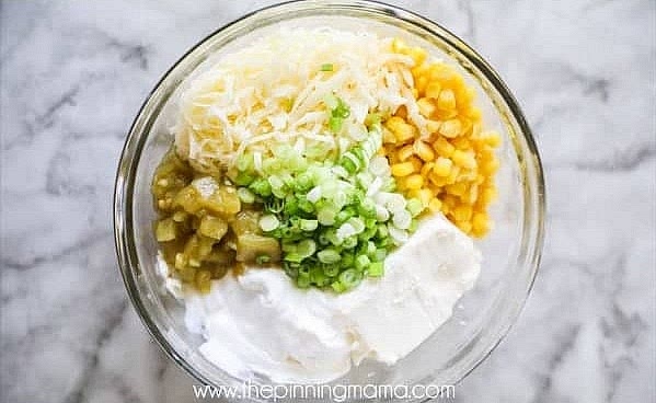 Mix the cream cheese, corn, green chiles, sour cream, and 1 1/2 cups Monterey Jack cheese until combined. Make sure that your cream cheese is well softened before mixing. You can either leave it at room temperature to soften, or you can put it in a microwave-safe bowl and heat it for 30 seconds, stir, then continue to heat for 10-second increments until it is warm and smooth.