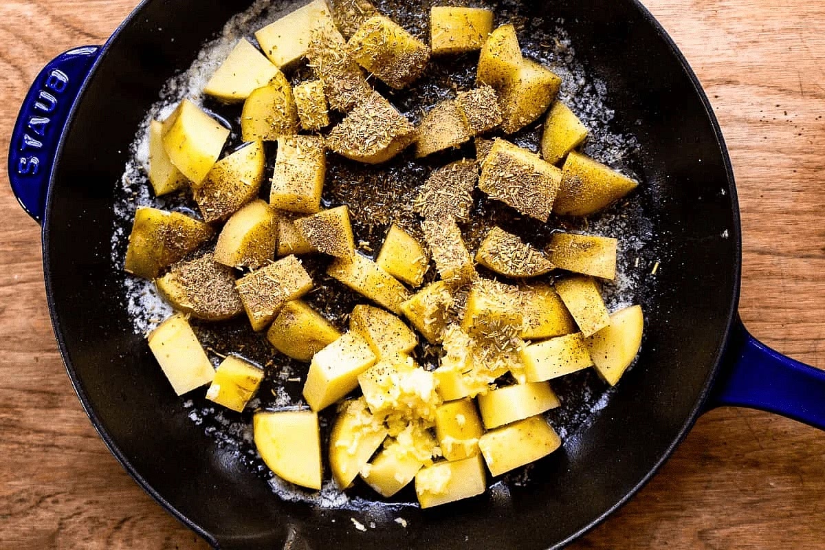 Add the cut potatoes, garlic, rosemary, oregano, salt, and pepper. Cook for approximately 4 minutes without disturbing. Stir and cook an additional 3-4 minutes, or until fork-tender. Remove the potatoes from the pan and set aside in a bowl.
*If potatoes are not tender (after 8 minutes) but are starting to get too brown, turn the heat to medium-low, add 2 tablespoons of warm water, cover, and cook for about 3-4 minutes until water evaporates.*